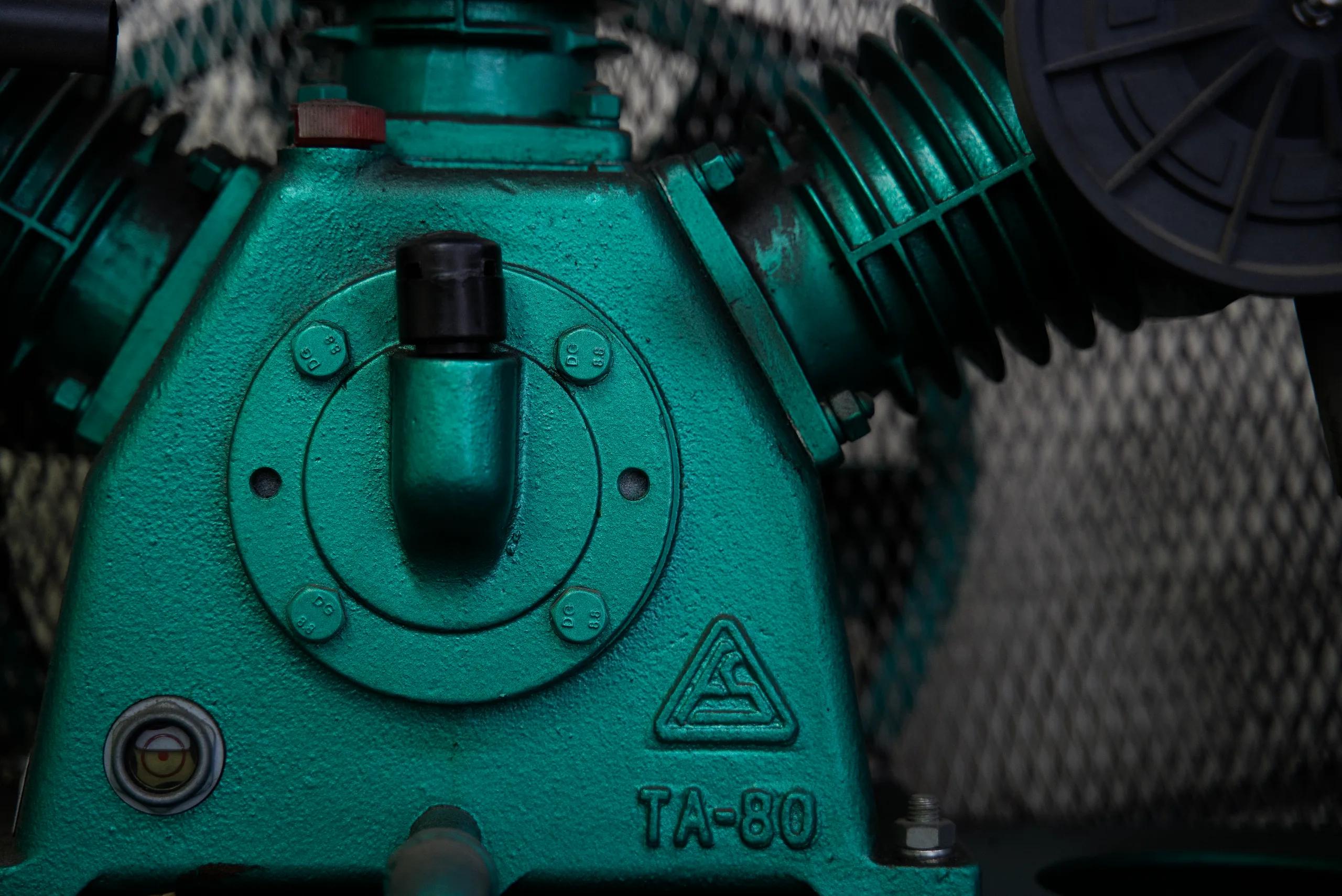 Close-up of a green workshop air compressor